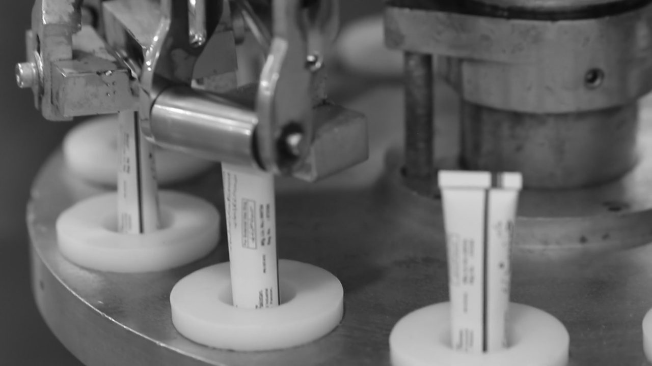 Silent looping clip of an automated pharmaceutical filling machine running tubes through a fill head.