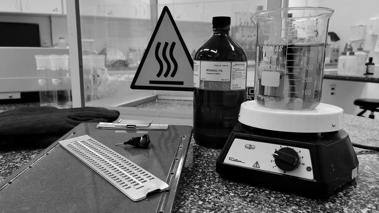 A hot plate stirring a chemical reaction on a laboratory bench