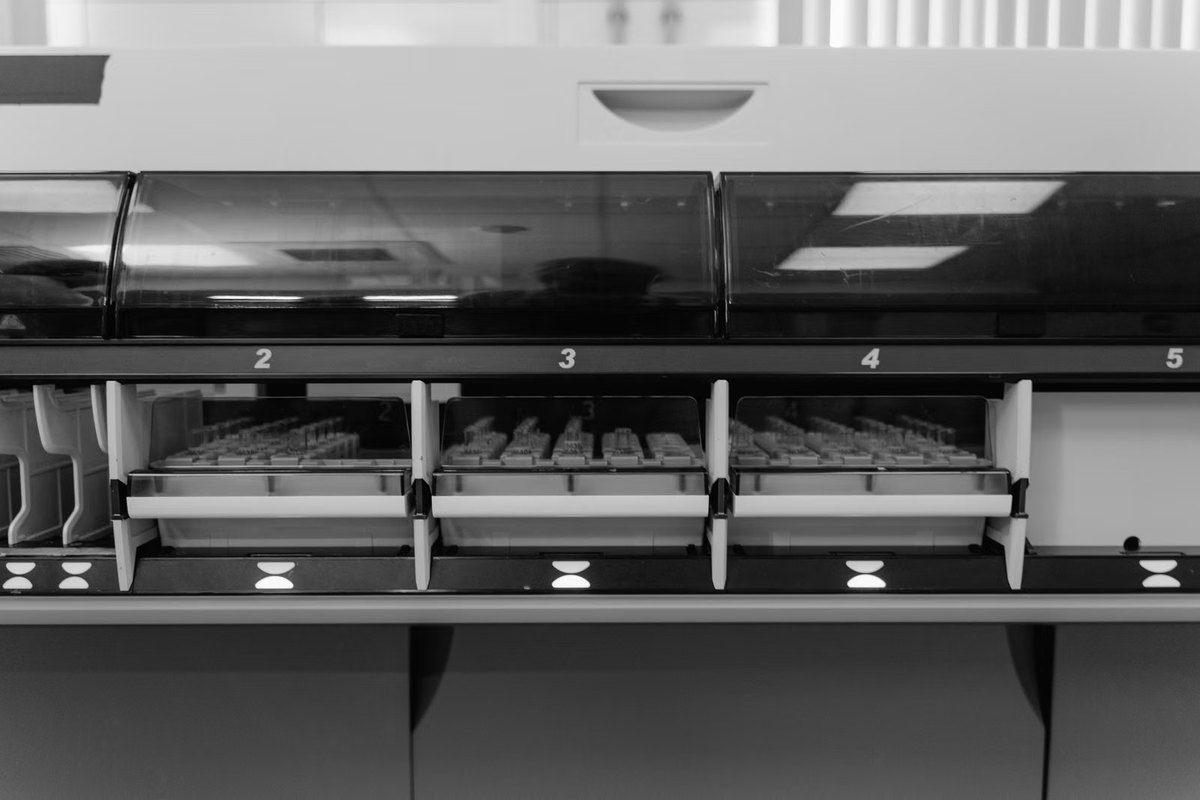 An automated analyser working through a tray of samples
